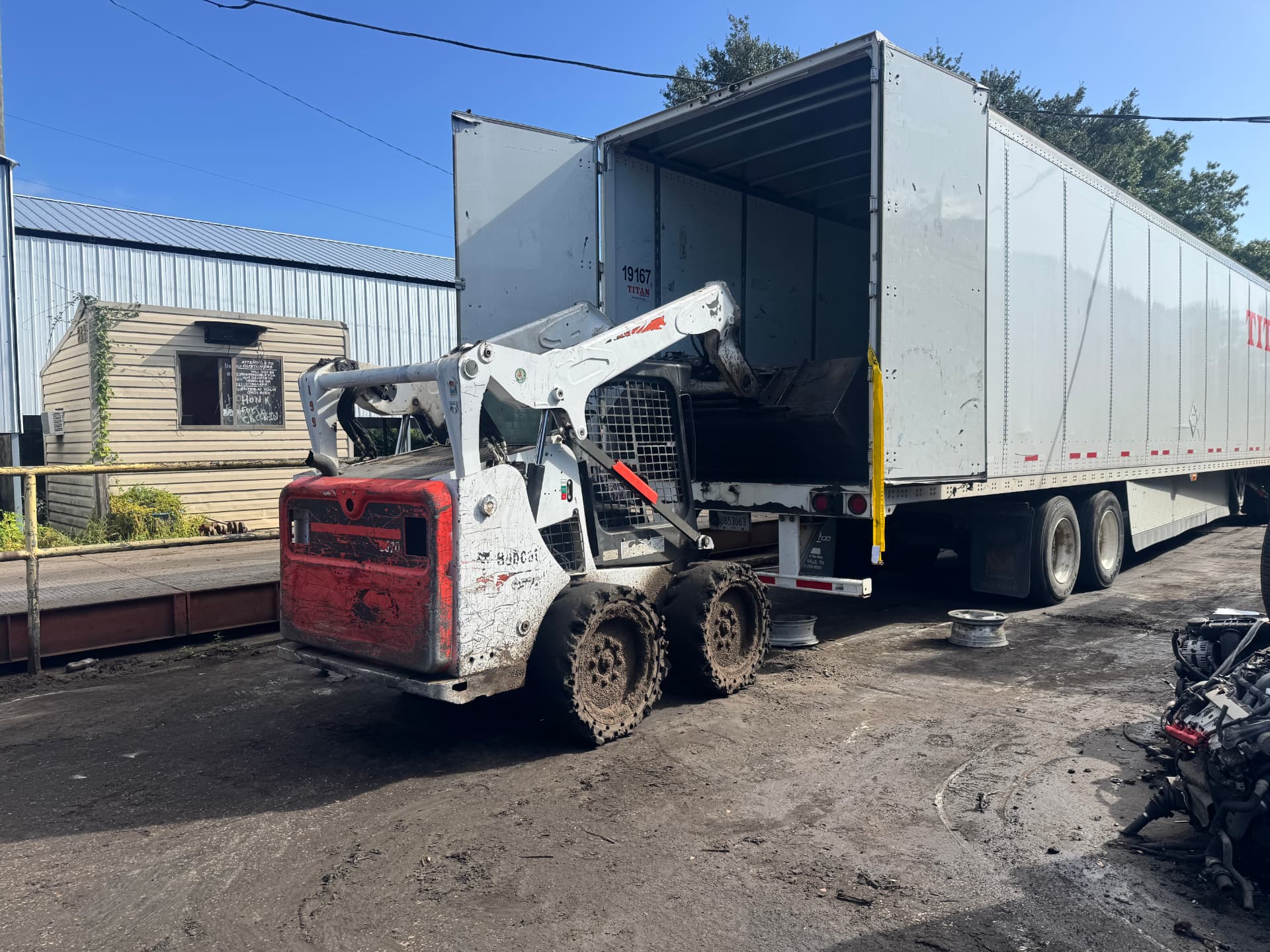 Skid steer loading a box truck