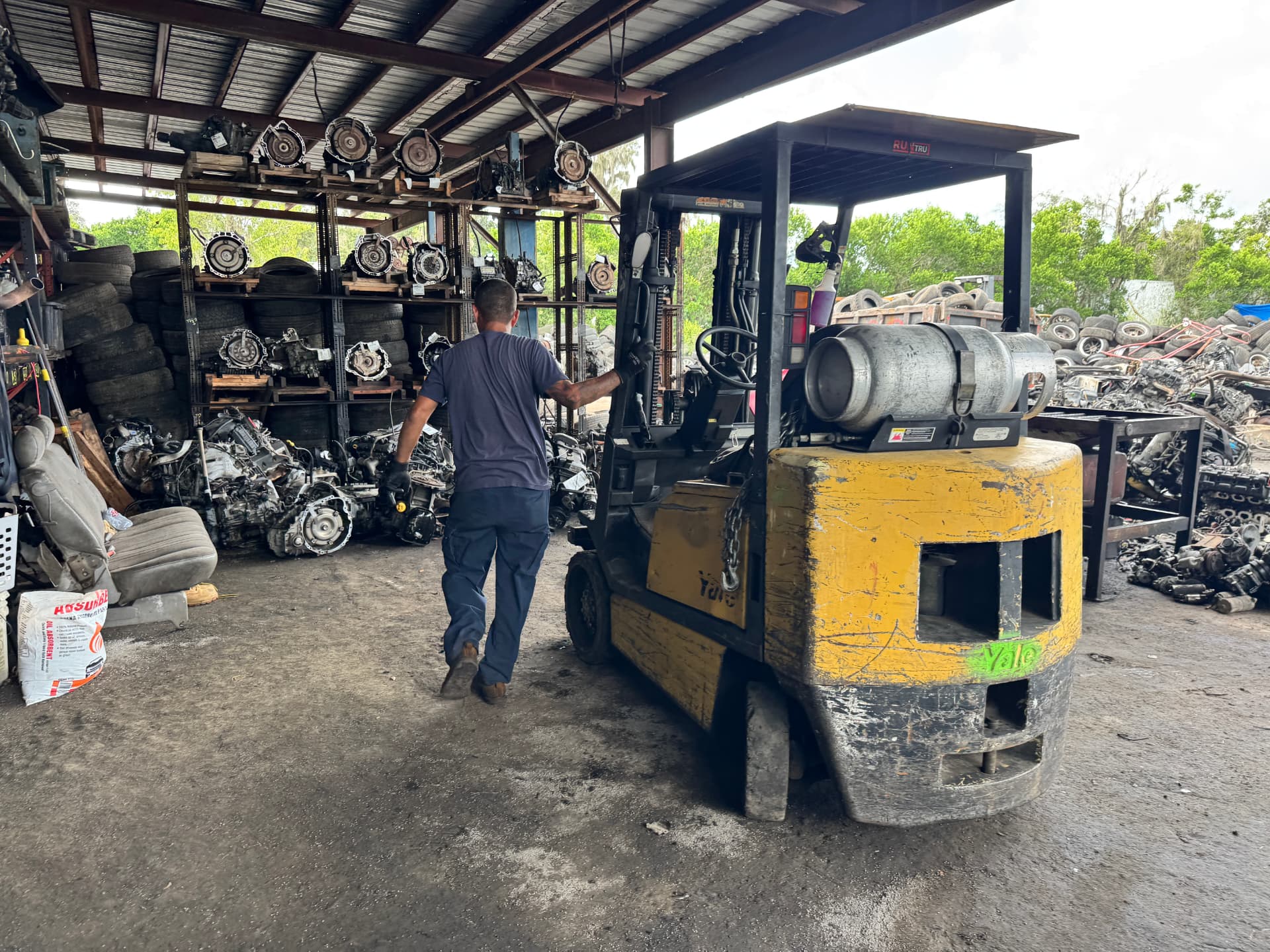 Worker and forklift inside the parts warehouse